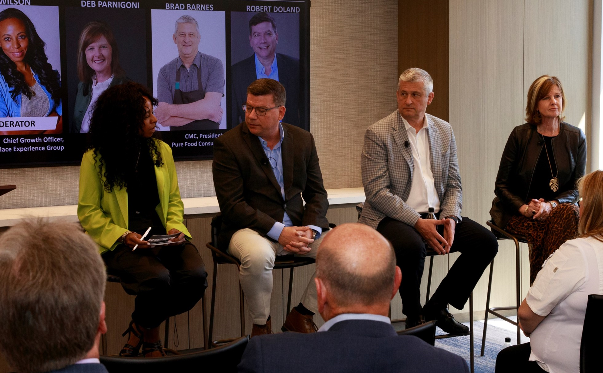 Panel of experts sitting in a row speaking to a group